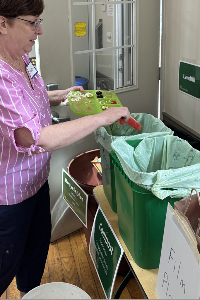 Woman throwing waste in to compost bins