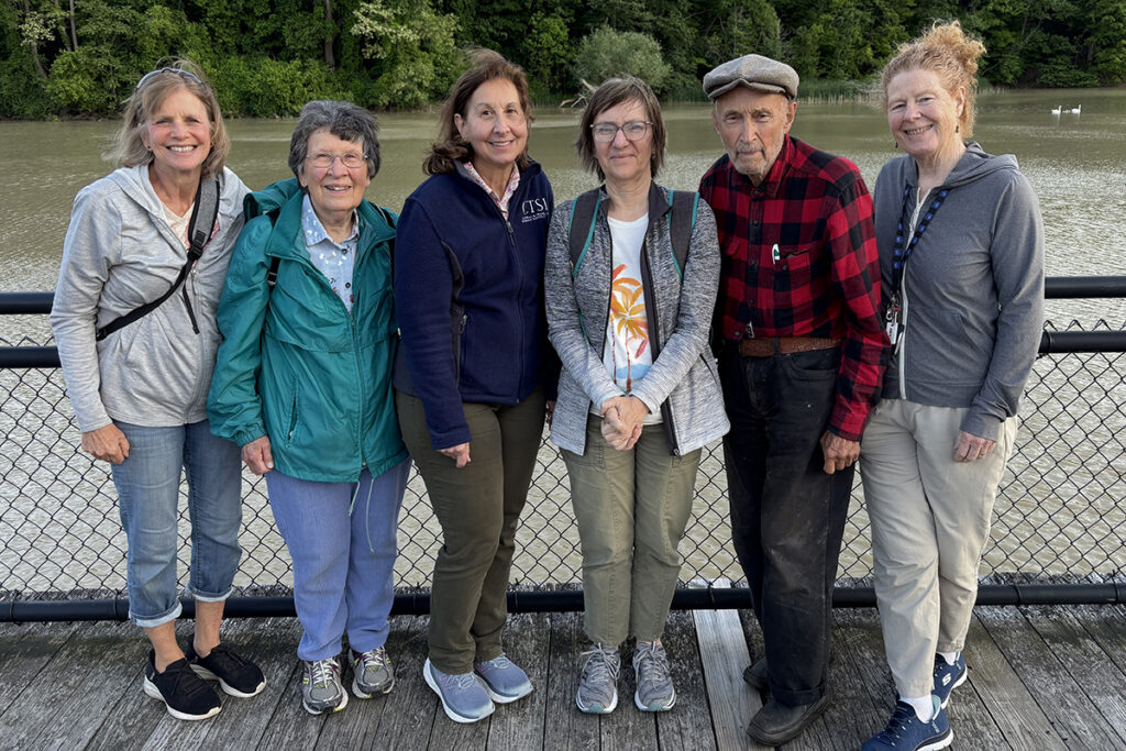 Members of the Mother Earth Community posing for a photo along the Genesee riverwalk